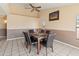 Dining room with dining room table, seating for six, floral arrangement, and nice ceiling fan at 6936 W Monterey Way, Phoenix, AZ 85033