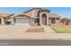 Charming single-Gathering home featuring a two-car garage, arched entryway, and well-manicured front yard at 6936 W Monterey Way, Phoenix, AZ 85033