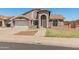 Quaint single-Gathering home with a two-car garage, arched entryway, and low-maintenance desert landscaping at 6936 W Monterey Way, Phoenix, AZ 85033
