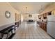 Spacious living room with dining area, built-in shelving, and a mix of tile flooring and two-tone neutral paint at 6936 W Monterey Way, Phoenix, AZ 85033
