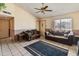 Comfortable living room with vaulted ceilings, tile floors, comfortable brown couches and dark accents at 6936 W Monterey Way, Phoenix, AZ 85033