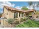 This backyard showcases a covered patio with stone pillars and a well-maintained artificial lawn at 6937 E Sierra Morena Cir, Mesa, AZ 85207