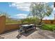 Outdoor patio dining area with a brick wall surround and beautiful landscaping at 6937 E Sierra Morena Cir, Mesa, AZ 85207