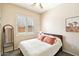 Bright bedroom with a queen-size bed, shuttered window, and stylish mirror at 6937 E Sierra Morena Cir, Mesa, AZ 85207