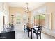 Inviting dining space featuring natural light, wine storage, and sleek wood-look flooring at 6937 E Sierra Morena Cir, Mesa, AZ 85207