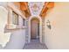 Arched doorway with stone detail, exterior lantern, and brick pathway creating a welcoming entrance at 6937 E Sierra Morena Cir, Mesa, AZ 85207