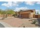 Charming home with brick driveway, desert landscaping, and tile roof, under a partly cloudy sky at 6937 E Sierra Morena Cir, Mesa, AZ 85207