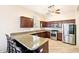 Spacious kitchen featuring stainless steel appliances, granite countertops, and a breakfast bar area at 6937 E Sierra Morena Cir, Mesa, AZ 85207