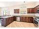 Gourmet kitchen showcases stainless appliances, light wood floors, and an open design for seamless entertaining at 6937 E Sierra Morena Cir, Mesa, AZ 85207