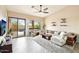Bright living room features a large sectional, plush rug, patio access, and scenic outdoor views at 6937 E Sierra Morena Cir, Mesa, AZ 85207