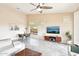Bright open-concept living area featuring a modern media center, wood look floors and large windows with shutters at 6937 E Sierra Morena Cir, Mesa, AZ 85207