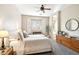 Serene bedroom with neutral tones, a bay window with shutters, and a cozy sitting area and light fixtures at 6937 E Sierra Morena Cir, Mesa, AZ 85207