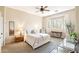 Inviting bedroom featuring a bay window with shutters, modern decor and soft, neutral color palette at 6937 E Sierra Morena Cir, Mesa, AZ 85207