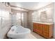 Bathroom featuring a tub, glass block shower, and wood vanity with granite counters at 7126 N 29Th Dr, Phoenix, AZ 85051