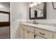 This bathroom features a granite countertop, marble backsplash, and a large decorative mirror at 7126 N 29Th Dr, Phoenix, AZ 85051