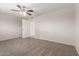 Bedroom with carpet, a ceiling fan and a view of closet and bathroom at 7126 N 29Th Dr, Phoenix, AZ 85051