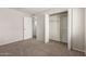 This bedroom features neutral walls, carpet, and a closet for storage at 7126 N 29Th Dr, Phoenix, AZ 85051