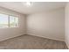 This bedroom features neutral walls, carpet, and a window letting in natural light at 7126 N 29Th Dr, Phoenix, AZ 85051