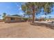 A single-story home with a brick exterior and a mature tree in the yard, offering shade and curb appeal at 7126 N 29Th Dr, Phoenix, AZ 85051