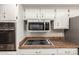 White kitchen cabinets with stainless steel oven, microwave, and range at 7126 N 29Th Dr, Phoenix, AZ 85051