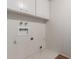 This laundry room features tile floors, cabinets, and washer and dryer hookups at 7126 N 29Th Dr, Phoenix, AZ 85051