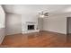 Spacious living room featuring hardwood floors and a charming painted brick fireplace, perfect for gatherings at 7126 N 29Th Dr, Phoenix, AZ 85051