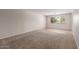 Spacious carpeted living room with a large window offering natural light, perfect for relaxation and entertaining at 7126 N 29Th Dr, Phoenix, AZ 85051