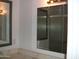 Bathroom featuring a large mirrored medicine cabinet, marble-look counter, and vanity lighting at 7821 W Clarendon Ave, Phoenix, AZ 85033