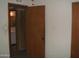 Hallway between bedrooms featuring neutral walls with flower pattern, doors, and tiled flooring at 7821 W Clarendon Ave, Phoenix, AZ 85033