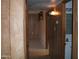 Hallway features wood paneling and tile flooring leading to bedrooms and bathrooms at 7821 W Clarendon Ave, Phoenix, AZ 85033
