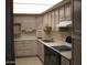 Efficient kitchen layout with ample cabinets, countertop, and black appliances at 7821 W Clarendon Ave, Phoenix, AZ 85033