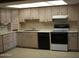 Efficient kitchen with tile floor, neutral cabinets, and modern appliances for functionality and style at 7821 W Clarendon Ave, Phoenix, AZ 85033