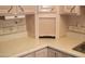 Corner kitchen countertop featuring a decorative backsplash, sink, and storage at 7821 W Clarendon Ave, Phoenix, AZ 85033