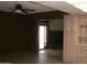 Cozy room with paneled walls next to a dining area with a charming brick fireplace at 7821 W Clarendon Ave, Phoenix, AZ 85033