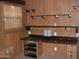 Office including a built-in desk, shelves, cabinets, natural light, and wood paneling at 7821 W Clarendon Ave, Phoenix, AZ 85033
