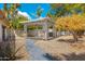 Landscaped backyard with a white wooden pergola and a winding stone tile path, offering a serene outdoor space at 7823 N Via Del Mundo --, Scottsdale, AZ 85258