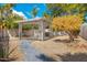 Landscaped backyard with a light grey wooden pergola and a winding stone tile path, offering a serene outdoor space at 7823 N Via Del Mundo --, Scottsdale, AZ 85258