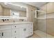 Modern bathroom featuring a double vanity, large mirror, and frameless glass shower with updated fixtures at 7823 N Via Del Mundo --, Scottsdale, AZ 85258