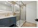 Elegant bathroom with a modern vanity, lighted mirror, and glass shower with gold fixtures at 7823 N Via Del Mundo --, Scottsdale, AZ 85258