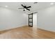 Bedroom with light wood floors and a sliding barn door with a ceiling fan above at 7823 N Via Del Mundo --, Scottsdale, AZ 85258