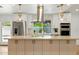 Bright kitchen with modern stainless appliances, island, and view of the backyard at 7823 N Via Del Mundo --, Scottsdale, AZ 85258