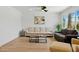 Bright living room featuring hardwood floors, neutral furniture, and large windows at 7823 N Via Del Mundo --, Scottsdale, AZ 85258