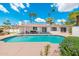 Backyard pool area featuring a pool, patio seating, and lush landscaping with palm trees at 7823 N Via Del Mundo --, Scottsdale, AZ 85258