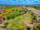An aerial view of a park featuring green spaces, a baseball field, and a playground at 7911 E San Miguel Ave # 3, Scottsdale, AZ 85250