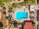 Aerial view of a community pool with a hot tub, lounge chairs, and shade at 7911 E San Miguel Ave # 3, Scottsdale, AZ 85250