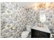 Stylish powder room features designer wallpaper, marble countertop, and gold fixtures at 7911 E San Miguel Ave # 3, Scottsdale, AZ 85250