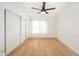 Bedroom featuring hardwood floors, a ceiling fan, and ample closet space at 7911 E San Miguel Ave # 3, Scottsdale, AZ 85250
