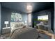 Bedroom features a bed, desk, large light fixture and wall decor at 7911 E San Miguel Ave # 3, Scottsdale, AZ 85250