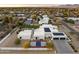 Aerial view of a modern luxury home with a pool, sport court, and desert landscaping at 8520 E Cactus Wren Rd, Scottsdale, AZ 85250