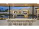 Backyard with a pool, outdoor kitchen, and bar seating, providing a luxurious space for entertaining and relaxation at 8520 E Cactus Wren Rd, Scottsdale, AZ 85250